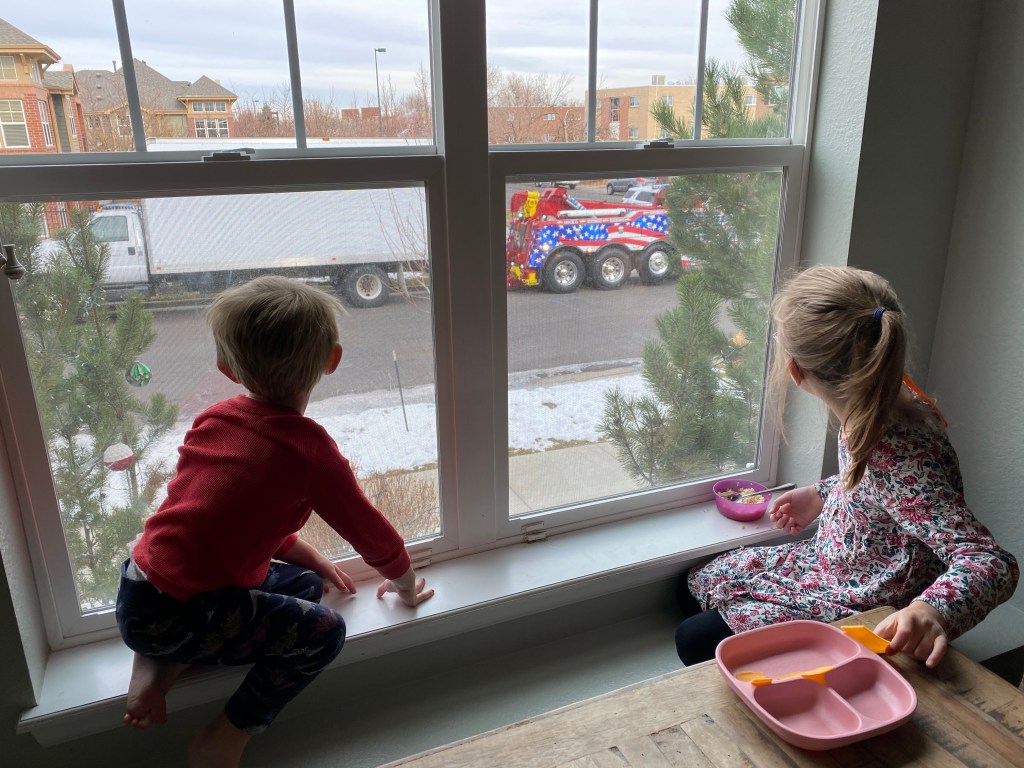 Kids watch as the criminals' truck is towed away.